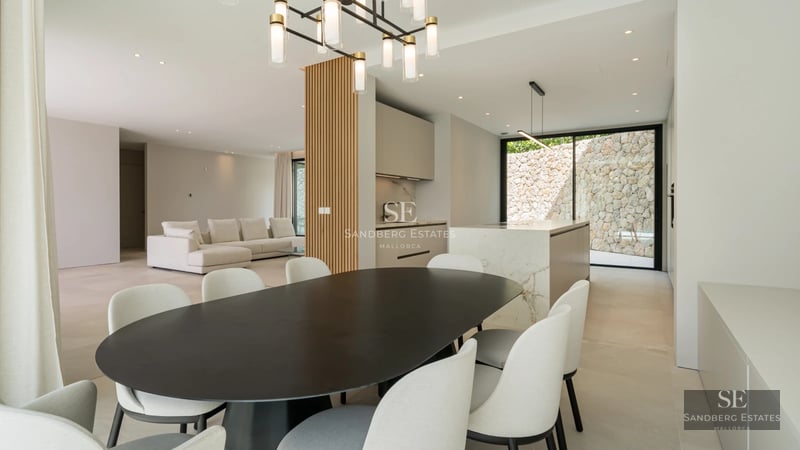 Spacious terrace with infinity pool, sun loungers, and panoramic sea views. Modern design with elegant furniture and lush greenery.