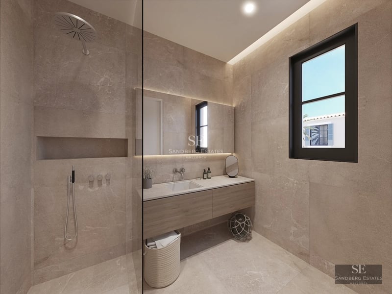 Exterior view of a modern house with pool, well-maintained garden and large windows reflecting sunlight.