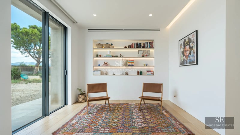 Modern exterior featuring a reflective pool, lounge chairs, lush greenery, and sleek architecture. Ideal for relaxed, luxurious living.