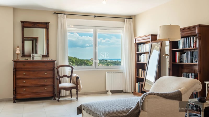 Spacious terrace with pool and unobstructed views. Modern design, elegant sun loungers, and lush vegetation.