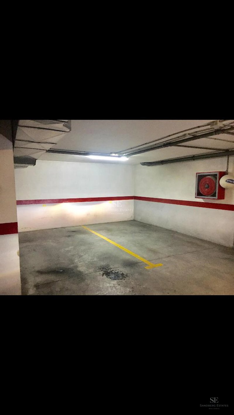 Bright living room with balcony, modern furniture, light wood floors, and panoramic view. Natural lighting and luxurious finishes.