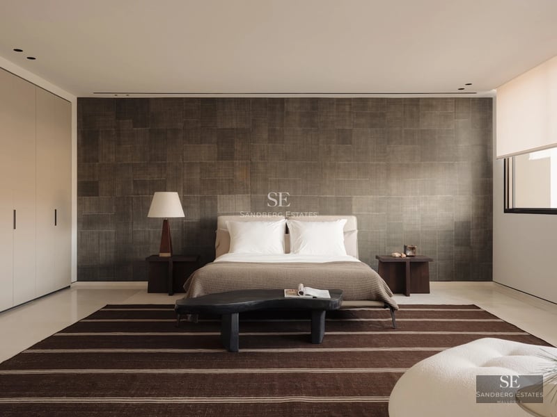 Exterior view of a modern villa with a pool, garden, and minimalist design. Large windows and elegant architecture.