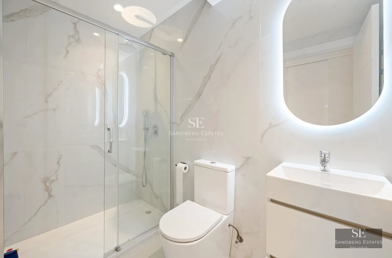 Spacious balcony with sea views. Modern furniture, glass railing. Perfect for relaxing and enjoying the sunset.