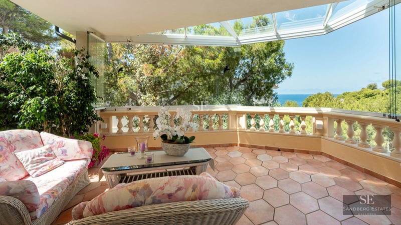 Spacious balcony with sea view from a modern apartment. Elegant design with outdoor furniture. Bright and airy.