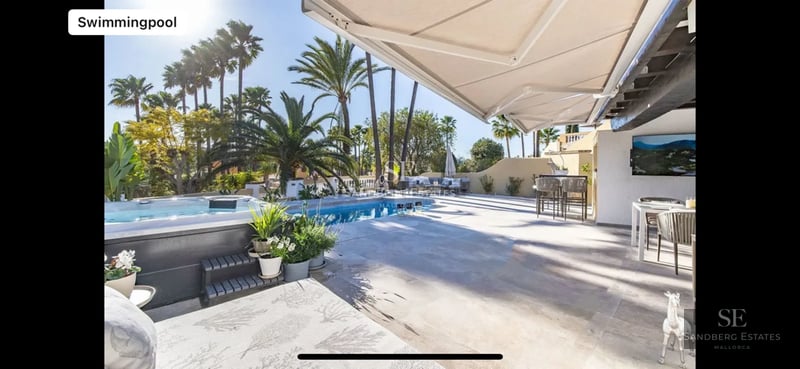 Modern villa with minimalist facade, reflecting pool, large windows, and lush vegetation. Elegant and contemporary architectural design.