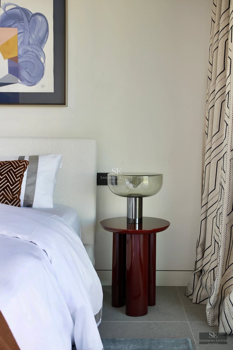 Spacious living room with panoramic windows, balcony with panoramic view, light wood floors, and modern designer furniture. Bright and elegant.