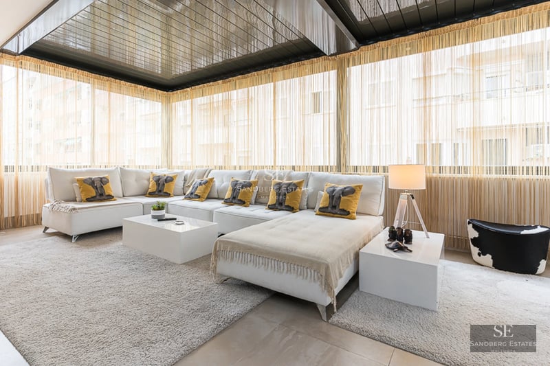 Spacious terrace with pool and sea views. Modern design with sun loungers, umbrellas, and lush vegetation. Ideal for relaxation.