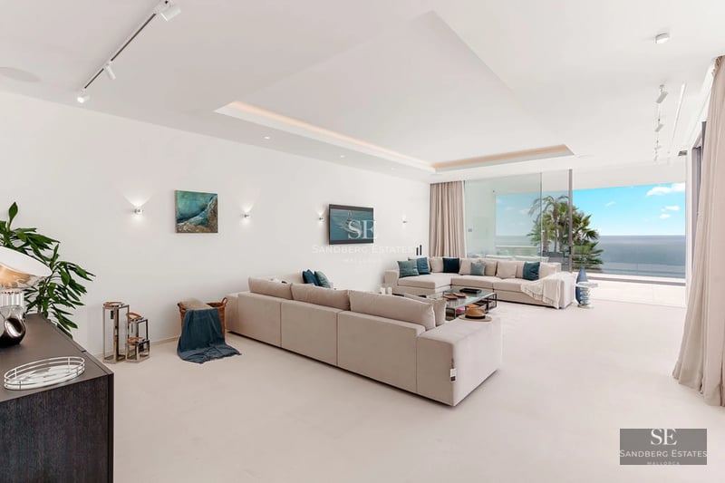 Exterior view of modern villa with pool, landscaped garden, and minimalist architecture. Large windows reflect natural light.