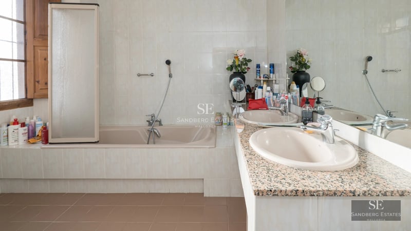 View of modern villa with reflecting pool. Minimalist architecture, large windows and lush landscaping.