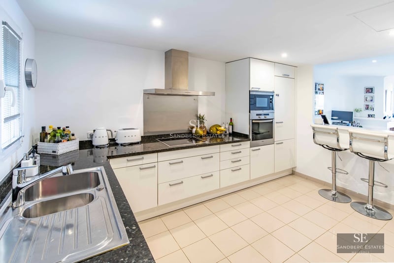 Exterior of a modern villa with infinity pool, large terraces, lush gardens, and panoramic views. Contemporary architecture.