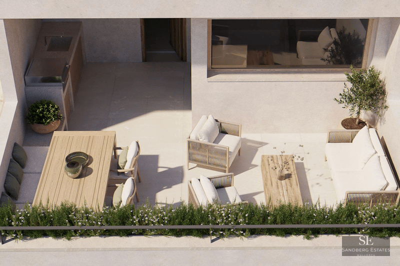 Bird's eye view of a sunlit modern terrace featuring a lounge area, dining table, and outdoor kitchen with a grill.