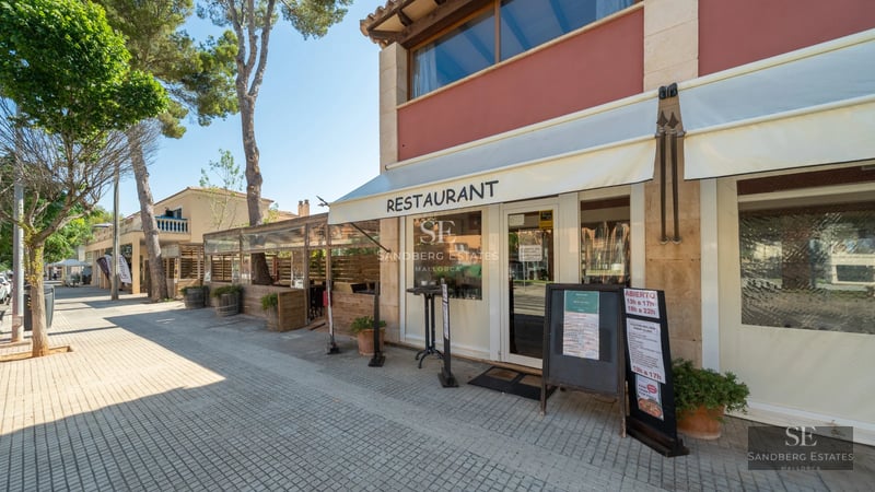 Exterior view of a modern villa featuring an infinity pool, manicured garden, and sleek architectural design. Warm ambient lighting.