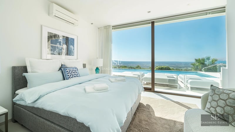 Spacious terrace with infinity pool, sun loungers, and panoramic views. Modern, elegant design with high-end outdoor furniture.