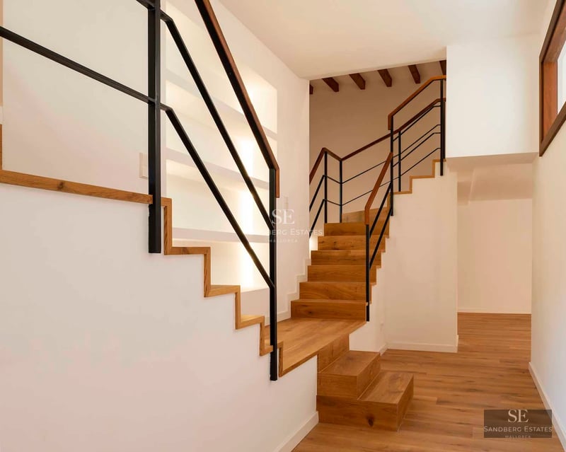 Spacious balcony with ocean views. Modern design with glass railing. Stylish and relaxing outdoor furniture.