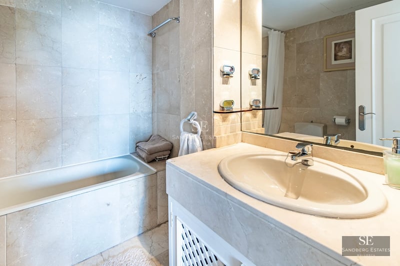 Exterior view of a modern villa with an infinity pool, spacious terraces, and lush gardens. Contemporary architecture with clean lines.