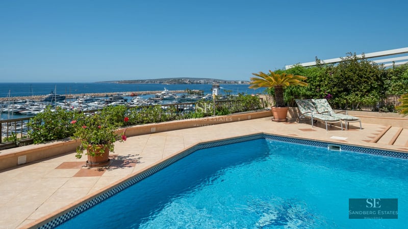 Spacious living room with balcony and sea view. Modern design, wood floors, and natural light.