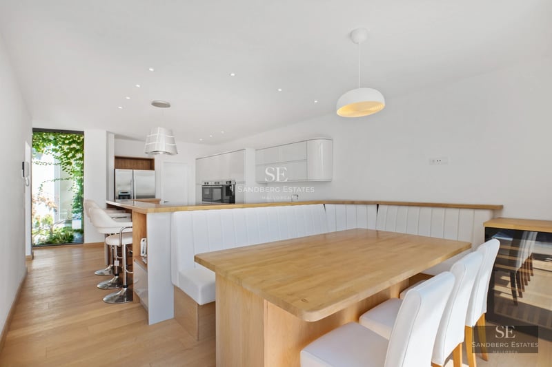 Exterior of a luxurious villa with a pool, garden and spacious terraces. Modern design with large windows and ambient lighting.