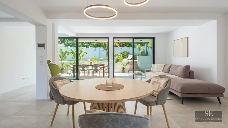 Spacious terrace with infinity pool, modern furniture, and panoramic views. Elegant and minimalist architectural design.