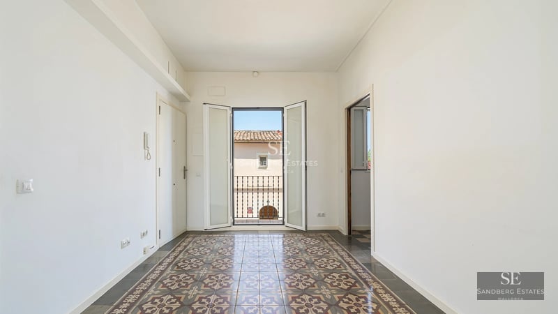 Infinity pool with vanishing edge, surrounded by green lawn and modern architecture. Large windows reflecting the blue sky.