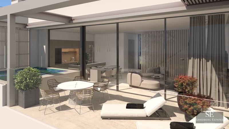 Modern terrace with dining area, sun loungers, and small pool next to glass-walled living and kitchen areas.