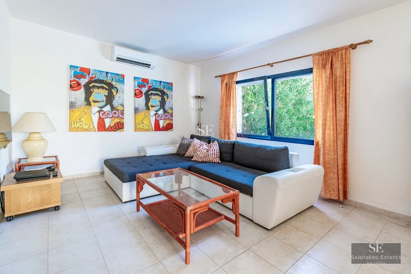 Exterior view of a modern house with a pool, lush garden, and large windows. Minimalist architecture and luxurious finishes.