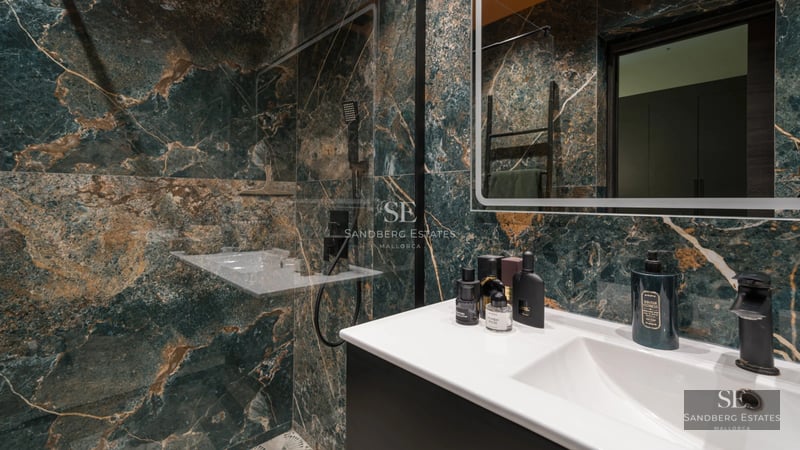 Minimalist facade with reflective pool. Modern design featuring large windows and lush greenery. Ambient lighting.