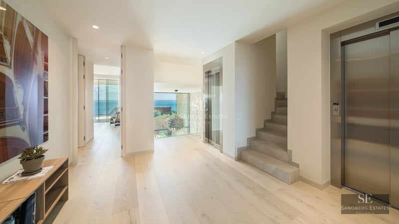 Modern exterior with infinity pool, expansive terraces, and panoramic views. Minimalist design with clean lines and abundant natural light.