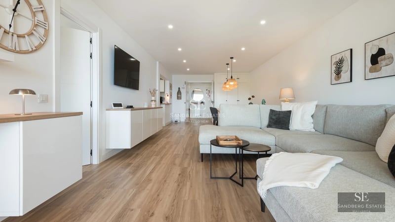 View of modern villa featuring a pool, spacious garden, and minimalist design. Large windows illuminate the interior.