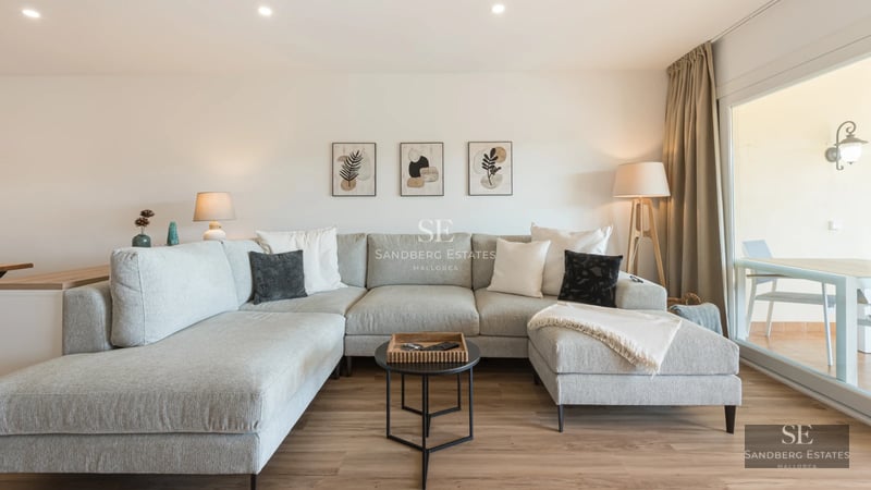 View of infinity pool surrounded by greenery and modern architecture with large windows and terrace. Luxury and outdoor design.