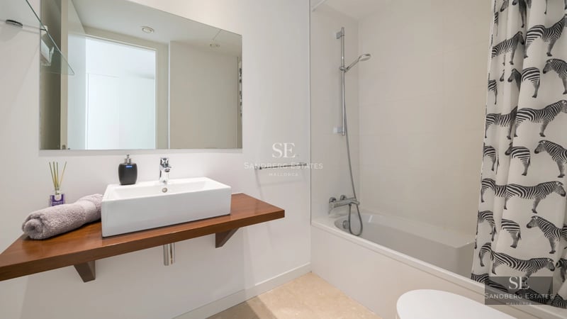 Aerial view of modern villa with infinity pool, manicured garden, and minimalist architectural design featuring clean lines.