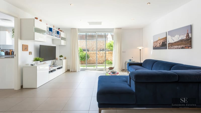 Bright living room with large windows, modern sofa, and panoramic sea view. Minimalist and elegant decoration.