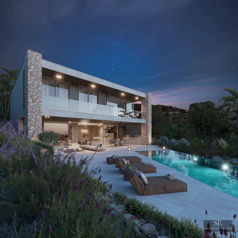 View of a luxurious, reflective pool surrounded by lush greenery & modern architecture. Natural stone & wood details are featured.