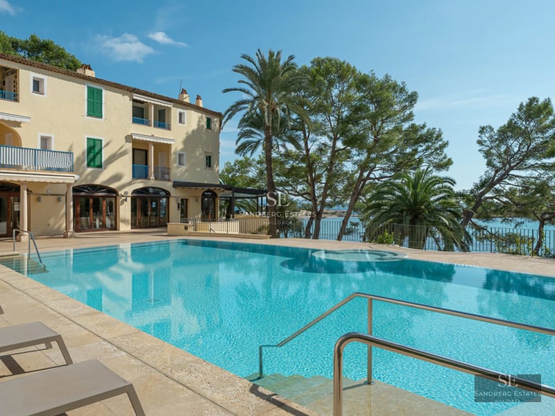 Aerial view of modern villa with pool, garden, and terrace. Minimalist architecture, large windows, and ambient lighting.
