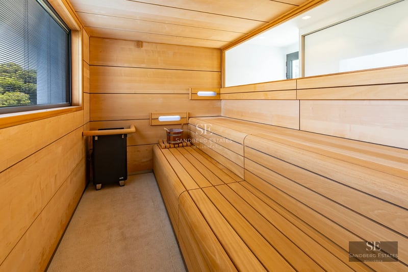 Exterior of a modern villa featuring a pool, garden, and large windows. Clean and contemporary architectural design.