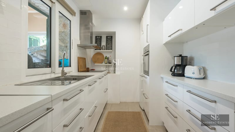 Spacious balcony with panoramic sea views. Modern and elegant furniture. Glass railing. Wooden floors.