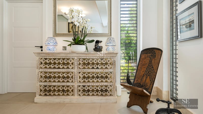 View of a luxurious villa with a pool, garden, and modern architecture. Large windows and elegant design.