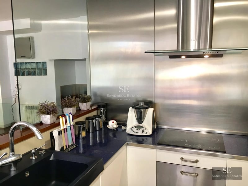 Exterior view of a modern house with pool, wooden terrace, and lush garden. Minimalist design with large windows and natural light.