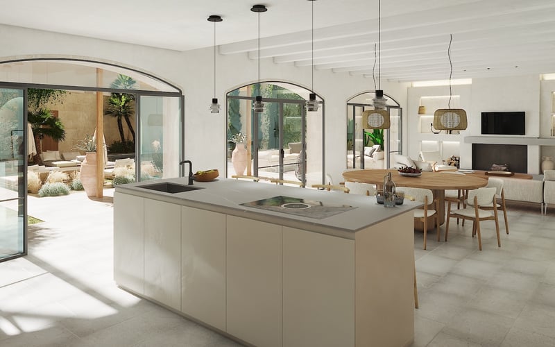 Îlot de cuisine moderne donnant sur la salle à manger et un patio méditerranéen via des portes cintrées.