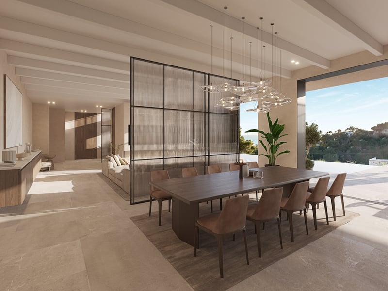 Espace dînatoire moderne avec table en bois sombre, chaises en cuir, cloison vitrée et grandes baies vitrées.