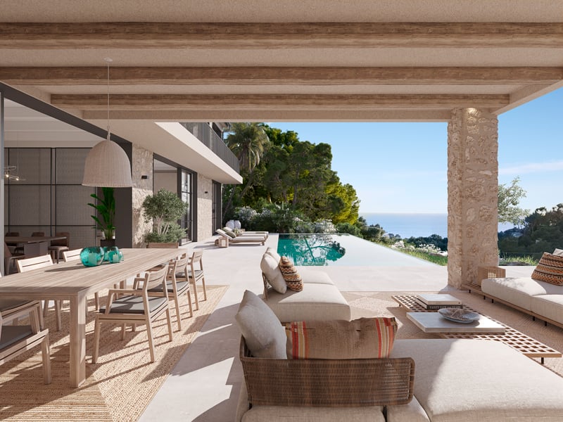Terrasse couverte avec poutres en bois, salon de jardin et piscine à débordement surplombant la mer.