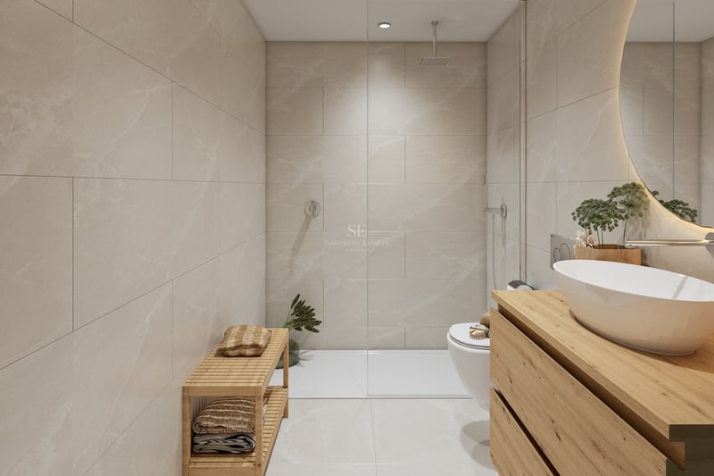 Modern bathroom with beige tiles, walk-in glass shower, wooden vanity, white vessel sink, and backlit circular mirror.