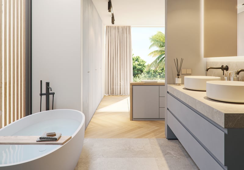 Minimalist bathroom with a freestanding tub, oak herringbone floors, and floor-to-ceiling windows overlooking palm trees.