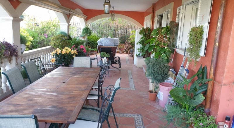 Spacious living room featuring a fireplace, panoramic sea view windows, and modern decor in neutral tones. Designer lamps and high-quality furniture.