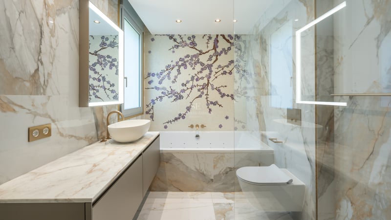 Luxury bathroom featuring Calacatta marble walls, a cherry blossom mosaic feature wall, and backlit LED mirrors.