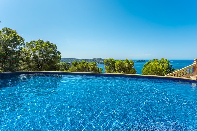 Spacious living room featuring panoramic windows, a modern fireplace, light wood flooring, and stunning views. Natural lighting and designer furniture.