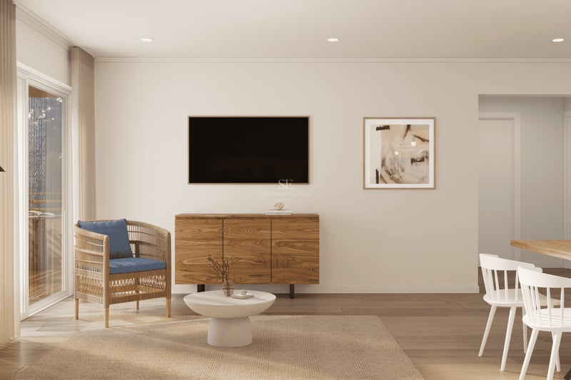 Salon moderne avec buffet en bois, TV, fauteuil en osier avec coussin bleu et coin repas lumineux.