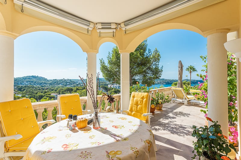 Spacious terrace with infinity pool and sea view. Modern furniture, wood flooring and glass railing. Sleek and minimalist design.