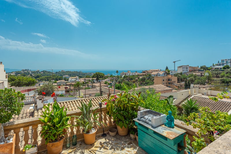 Image of a modern villa with a pool, large window, and minimalist design. Green lawn and blue sky.