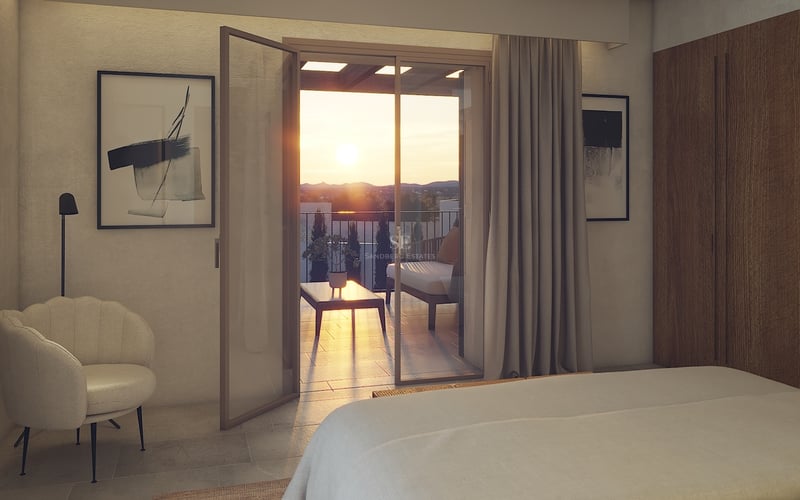 Chambre contemporaine avec baies vitrées ouvrant sur une terrasse surplombant une vallée au coucher du soleil.