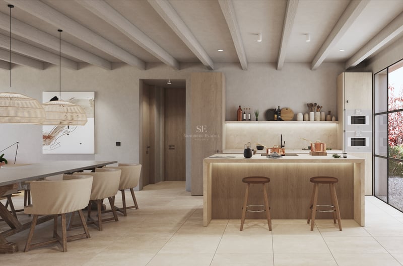 Cuisine moderne avec îlot en bois clair, poutres apparentes et électroménagers intégrés près de la salle à manger.